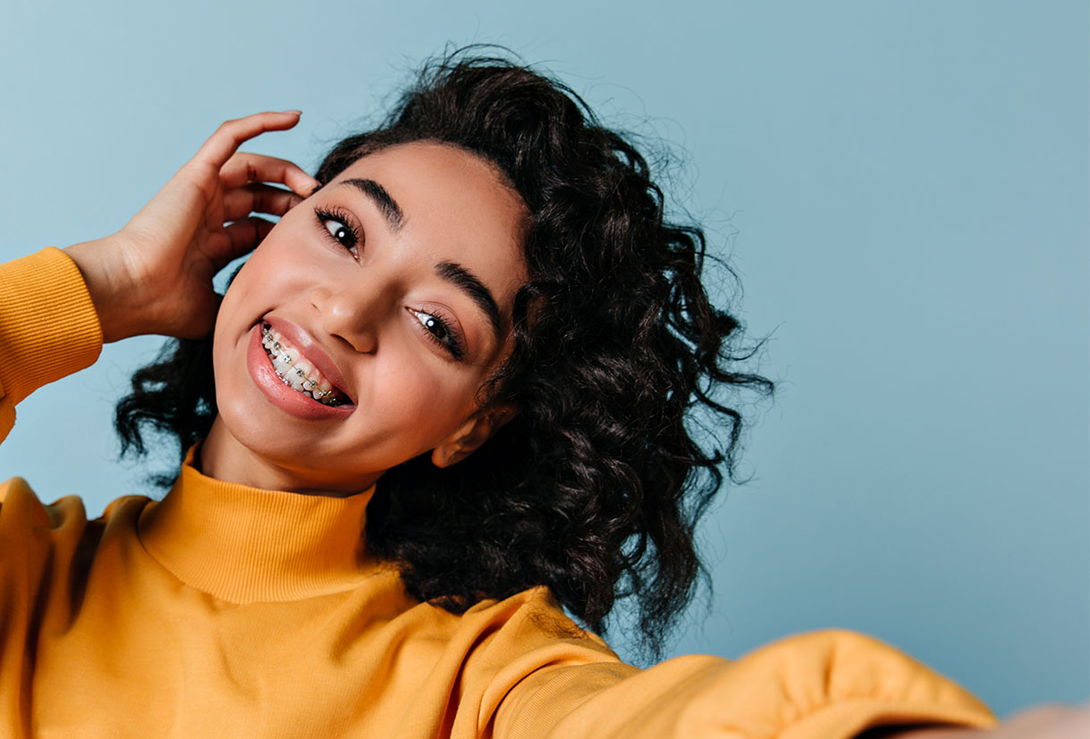 girl smiling with ceramic bracket braces